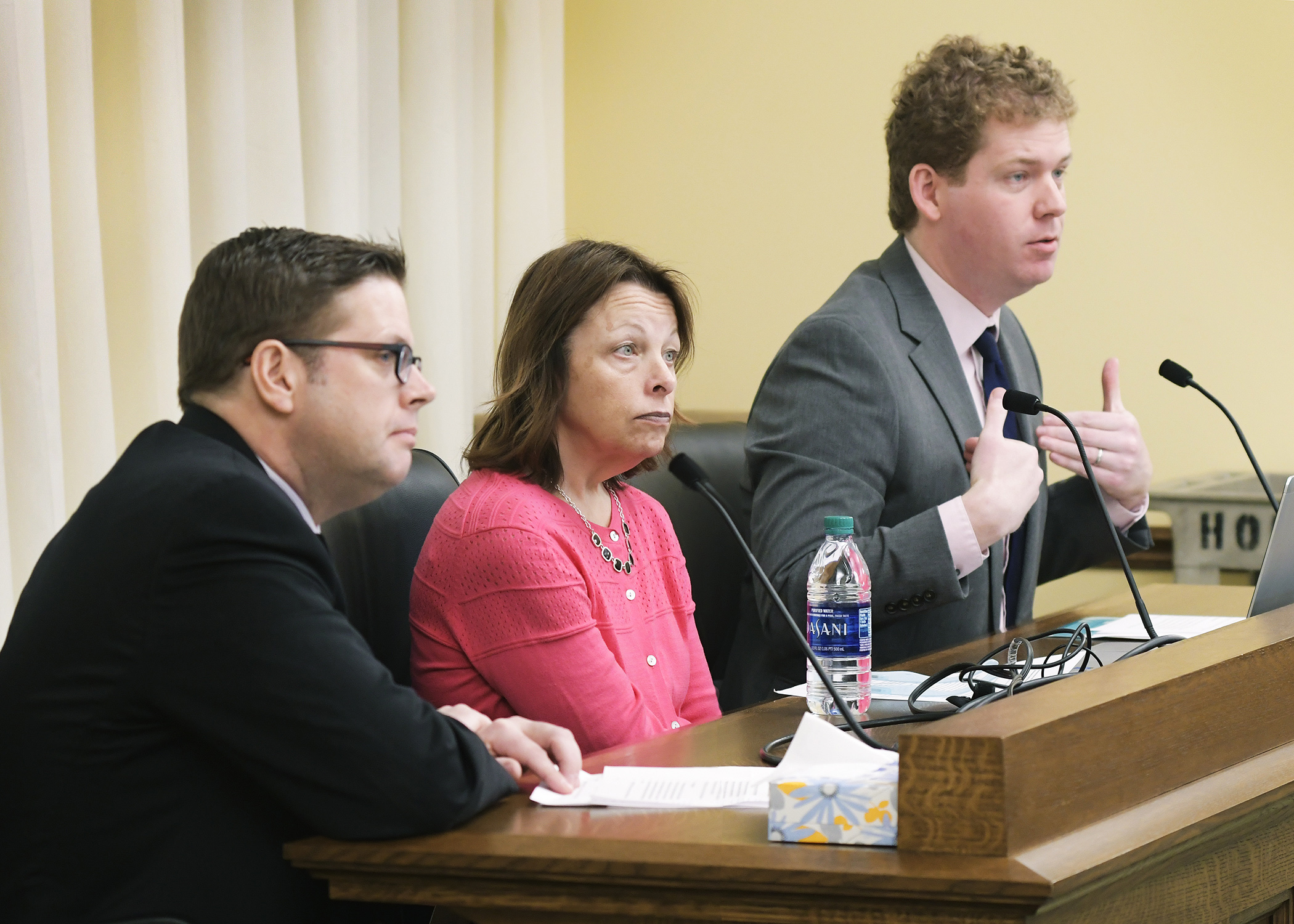 Jim Pearson, state government affairs manager for Xcel Energy, and Mona Meyer, state council president of the Communications Workers of America, testify before the House Energy and Climate Finance and Policy Division March 21 in support of a bill sponsored by Rep. Zack Stephenson, right, to require the Metropolitan Council to purchase electric busses. Photo by Andrew VonBank